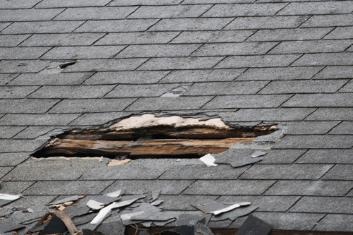 Close-up of a hole in shingle roofing