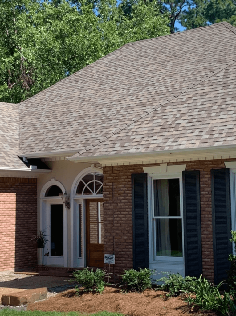 Residential roof done by Pride Roofing LLC of Hammond, La. using Atlas shingles image of red brick home with close up of roof