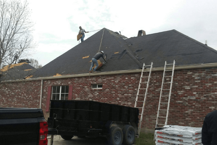 Pride Roofing LLC construction workers installing shingles on a residential property