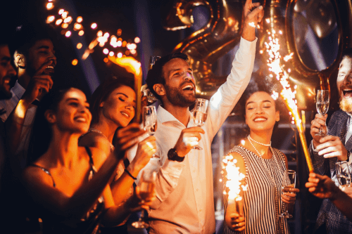 New Year's Resolutions For Your Louisiana Roof! with Pride Roofing LLC. Image of New Years Eve party goers celebrating with champagne and sparkler fire works