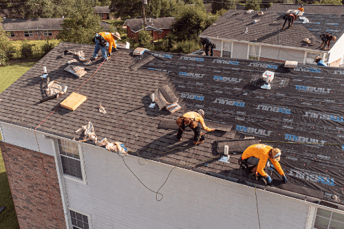Common Commercial Roof Repairs And How You Can Prevent Them | Pride Roofing LLC in Southern Louisiana. Image of roof contractors repairing the roof of a commercial building.