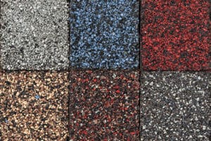 Roofing material asphalt shingles samples of various colors.