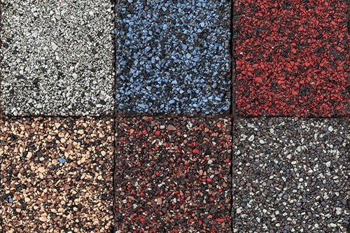 Roofing material asphalt shingles samples of various colors.