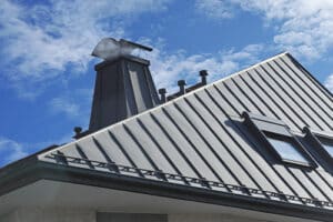 PBR Roof vs. Standing Seam | Pride Roofing in Albany, LA., image of Modern Standig Seam Metal Roof with Roof Window, Fume Hoods, Snow Guard, rain Gutter and Metal plastered Chimney