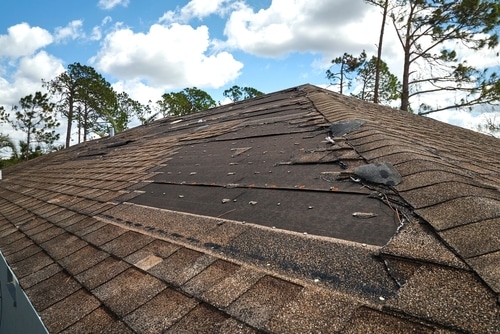 Roof Insurance Claims in Hammond, LA with Pride Roofing LLC. image of Damaged roof of house, highlighting the need for insurance claims assistance for roof repairs