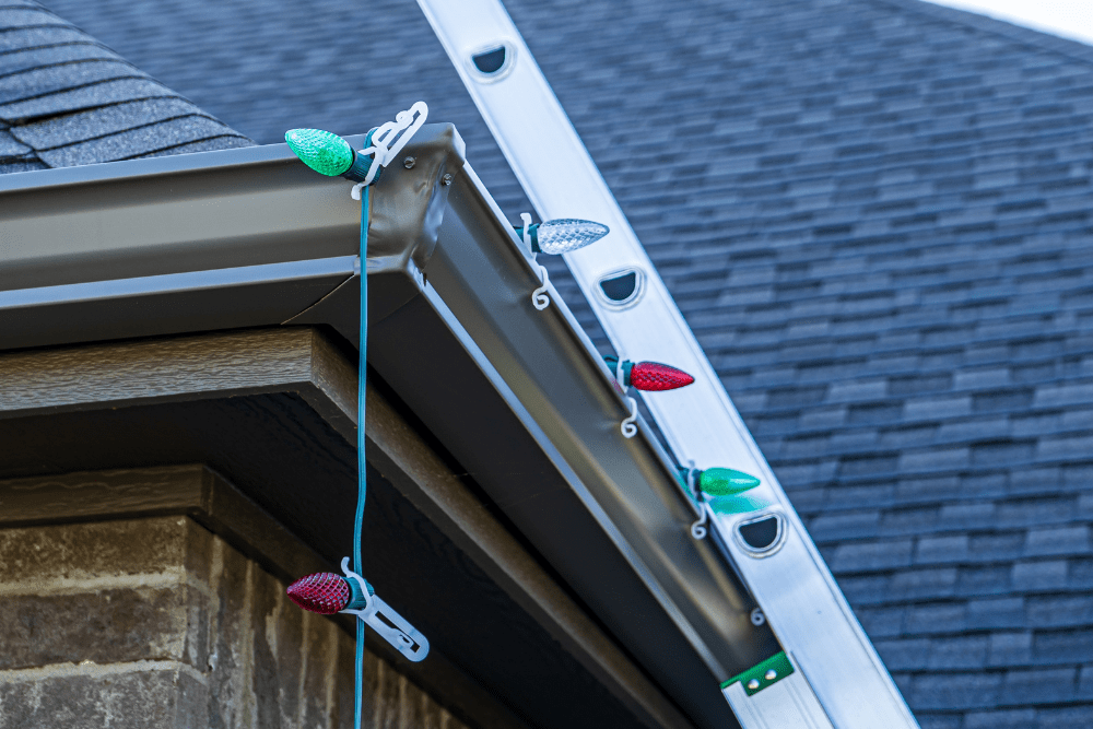 Post-Holiday Roof Maintenance, roofing and construction expert in Hammond, LA at Pride Roofing LLC. An Image of a roof with hanging Christmas lights.