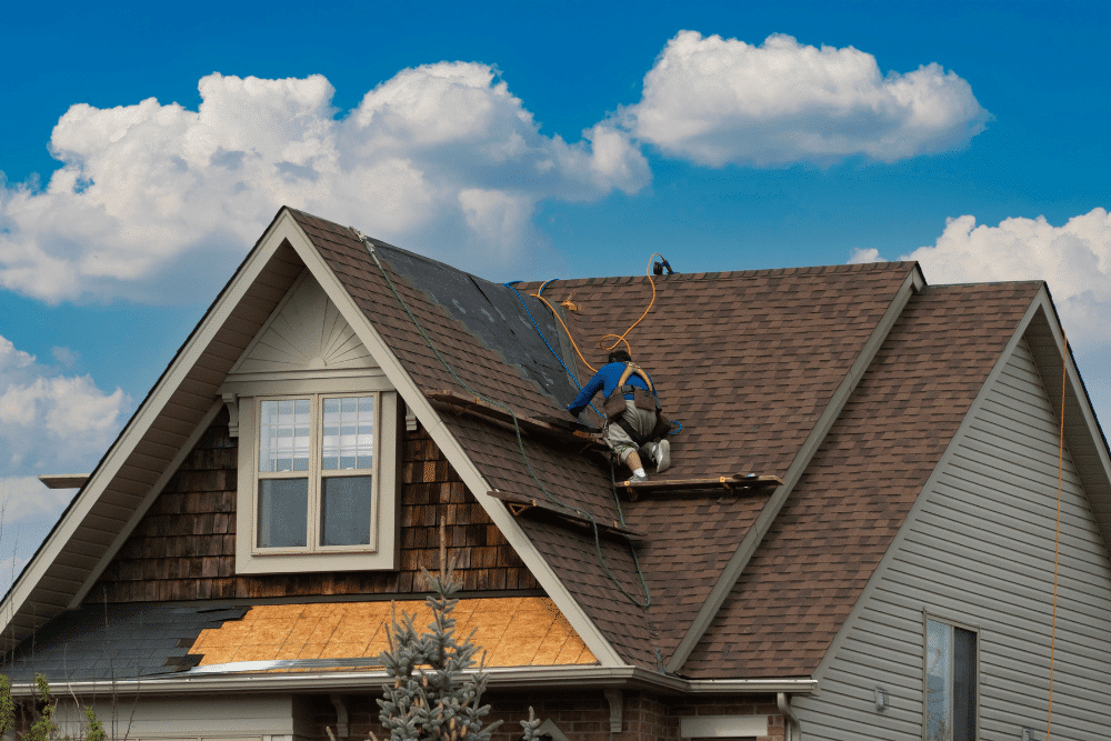 spring roofing maintenance, roofing and construction expert in Hammond, LA at Pride Roofing LLC. Roofer wearing safety gear working on a steep residential roof during a shingle replacement