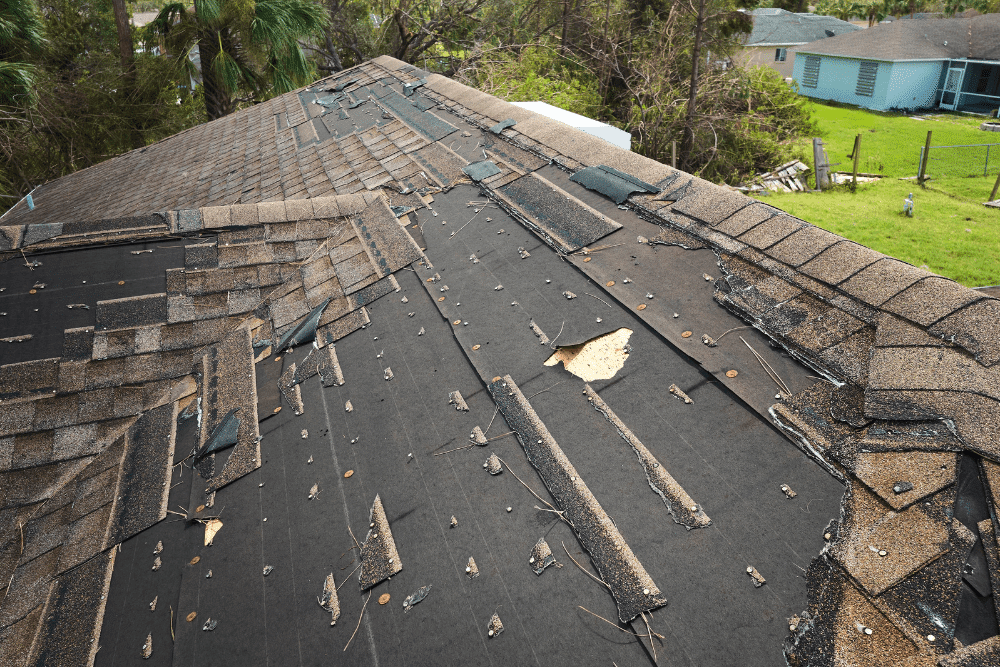 Hidden roof damage, residential roofing in Hammond, LA by Pride Roofing LLC. Image showing missing and torn asphalt shingles exposing underlayment, highlighting the need for professional roof repair and replacement services after severe weather.