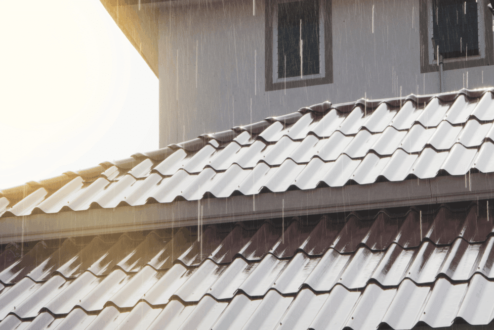 Roof repair in Hammond, LA by Pride Roofing LLC. Image of a metal roof during rainfall, highlighting durable roofing materials designed to protect homes from heavy rain, moisture intrusion, and long-term weather damage.