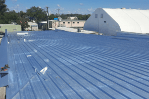 Commercial roof repair in Hammond, LA at Pride Roofing LLC. Image of metal roof on commercial building, highlighting durable structure supporting safe and reliable service.